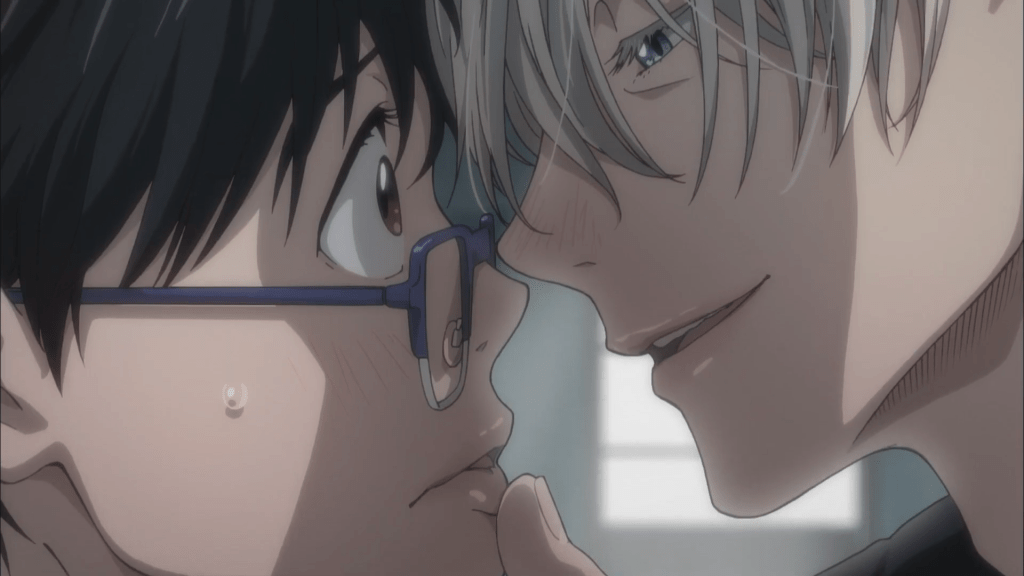 Yuuri Katsuki looking flustered while Victor holds his mouth as their foreheads and noses touch.